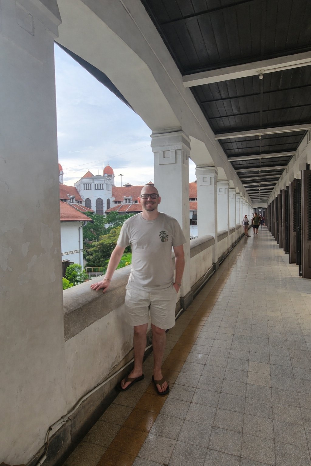 Koby in a colonial arched corridor