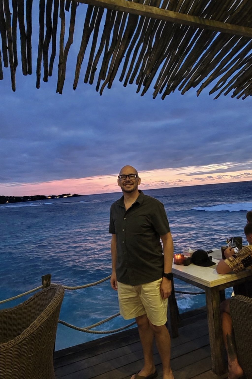 Koby at a sunset bar over the ocean