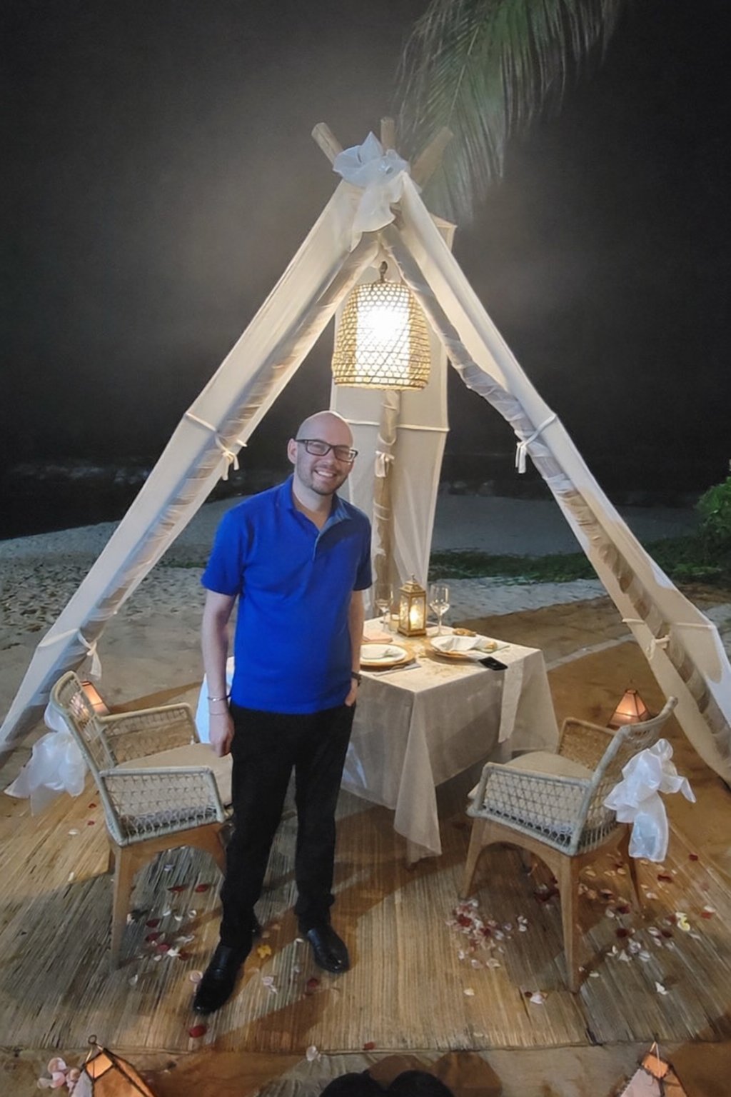 Koby at a private beach dinner under a teepee